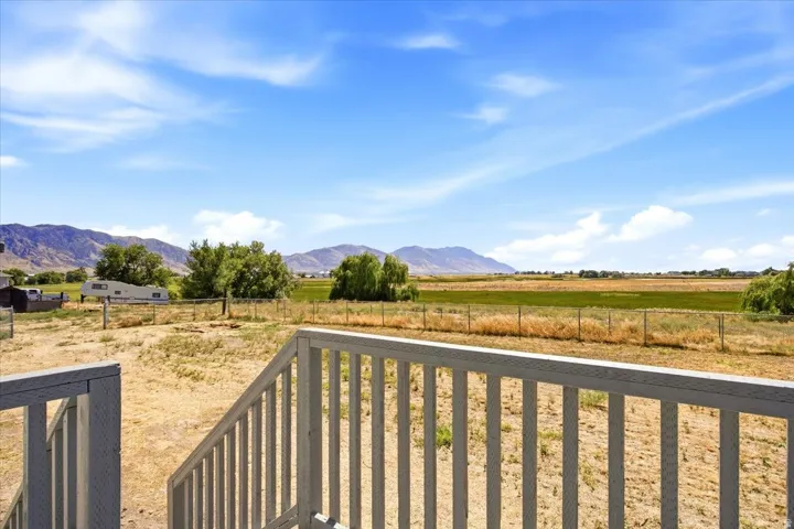 Expansive rural landscape featuring distant mountains and open fields