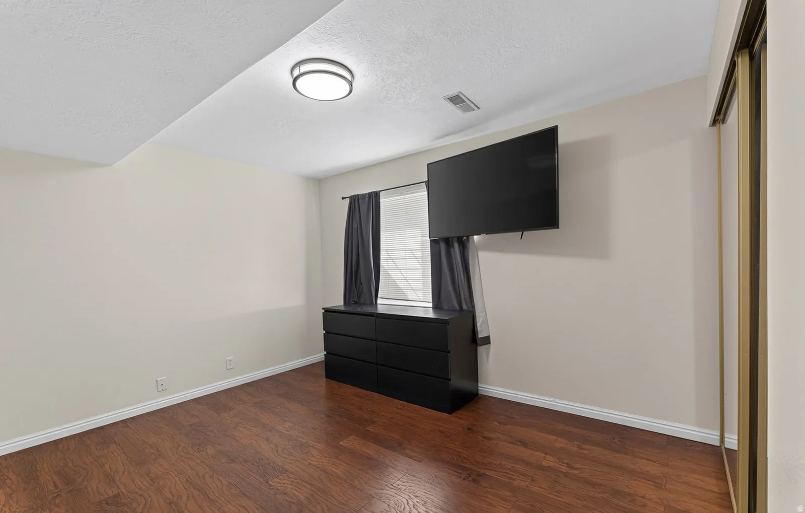 Rich wood-finish flooring with light-toned walls