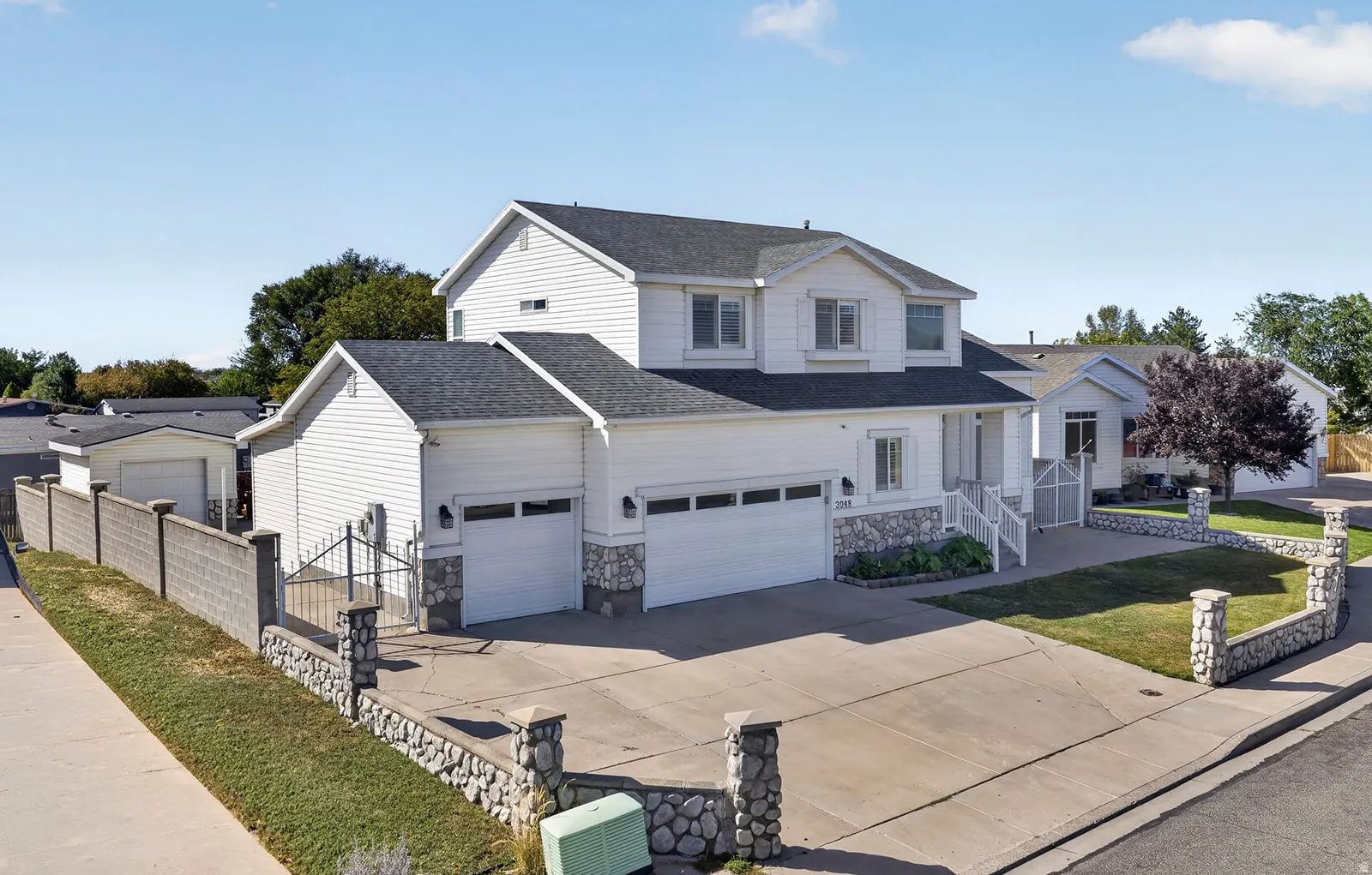 Two-story residence with white siding and a dark roof