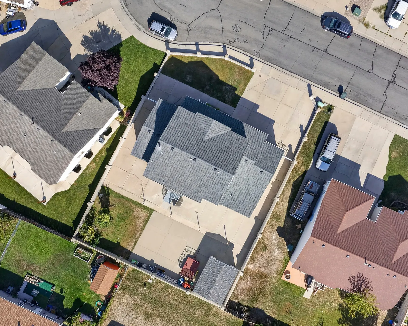 Paved driveway access, fenced perimeter, and established landscaping