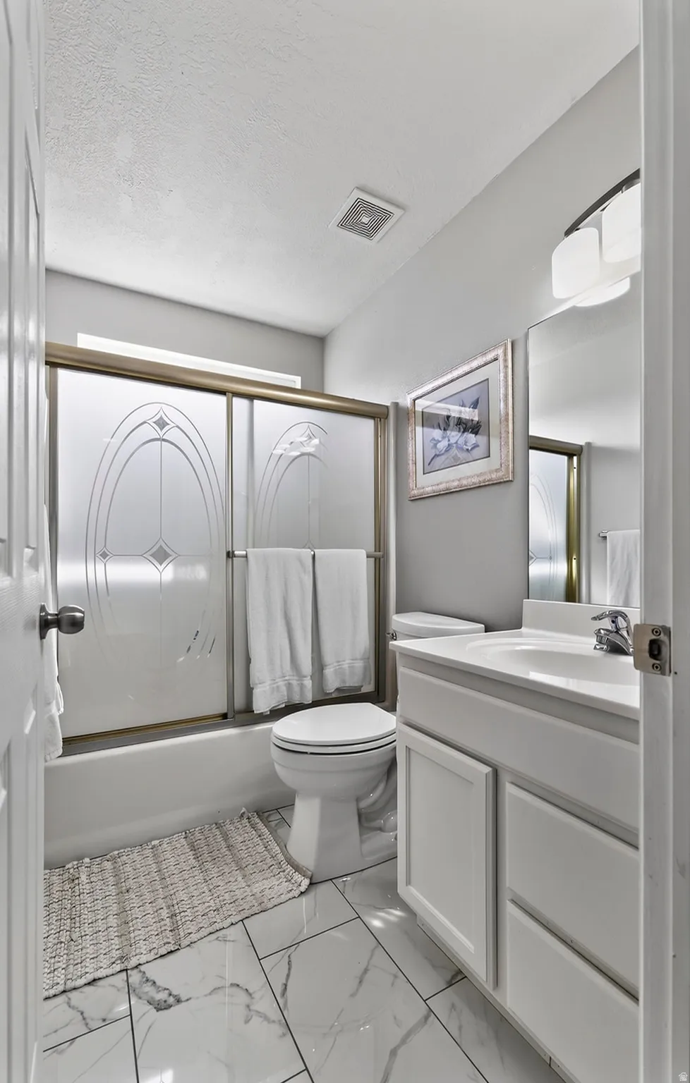 White vanity with under-sink storage, built-in mirror, and contemporary light fixture