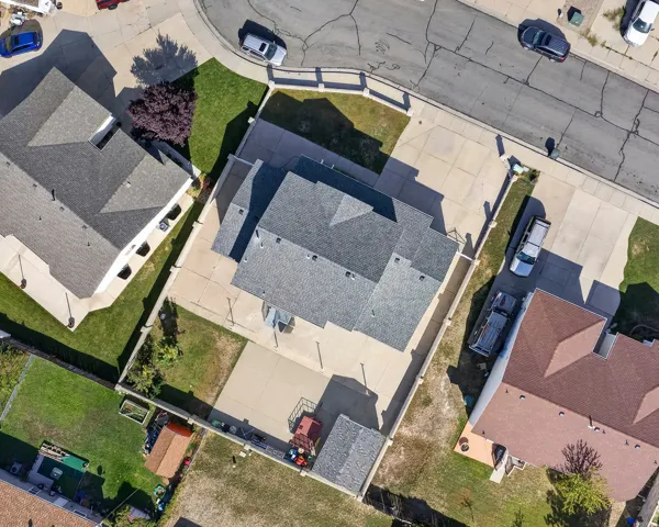 Paved driveway access, fenced perimeter, and established landscaping