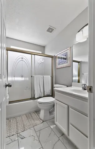 White vanity with under-sink storage, built-in mirror, and contemporary light fixture