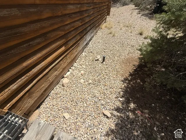 Log cabin exterior with gravel landscaping