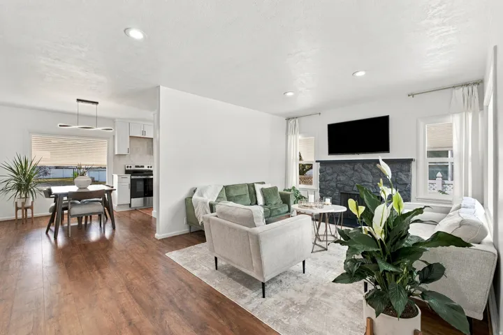 Wood-finish flooring throughout, recessed lighting, and a stone-clad fireplace