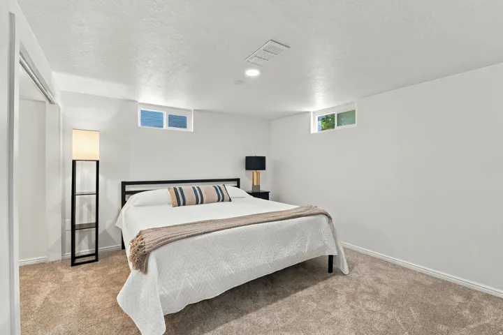 Recessed lighting, light-colored walls, and windows provide illumination
