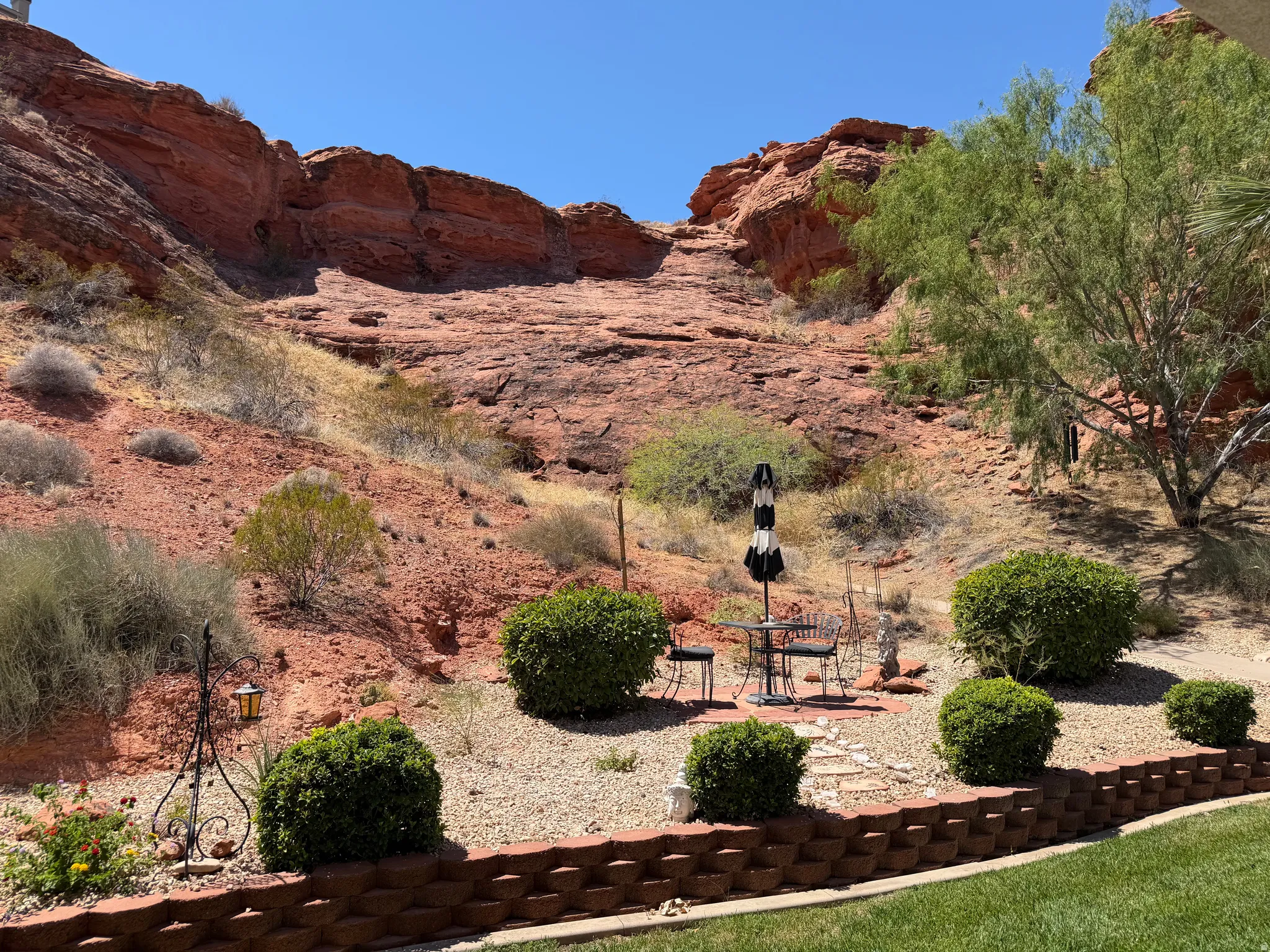 Terraced landscaping with a stacked stone retaining wall and gravel hardscaping