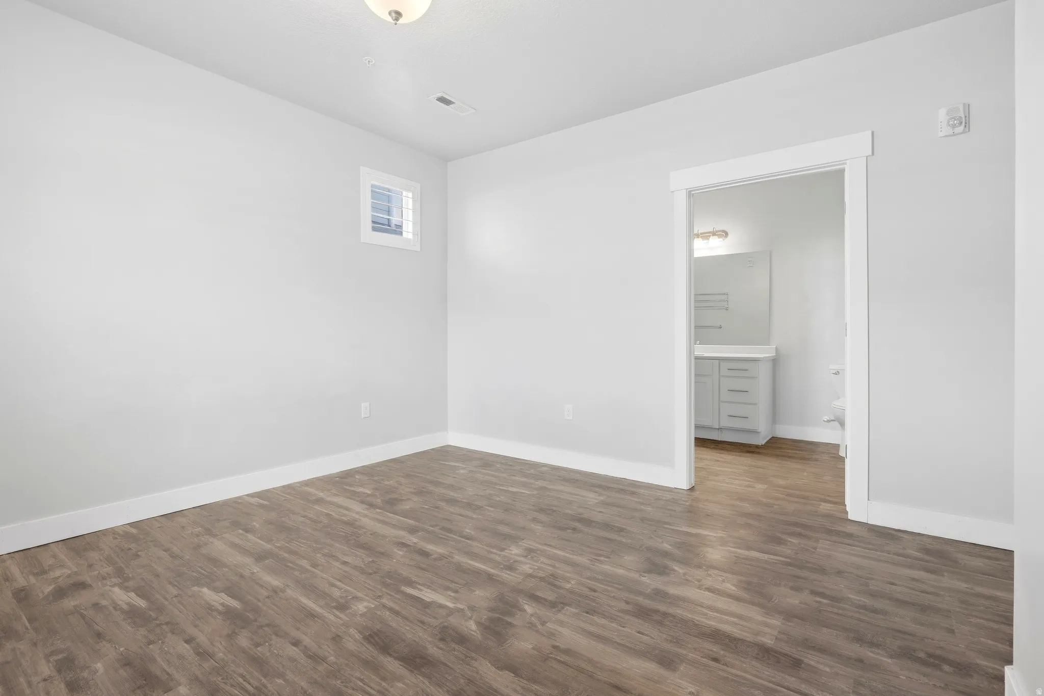Wood-finish flooring with white trim throughout