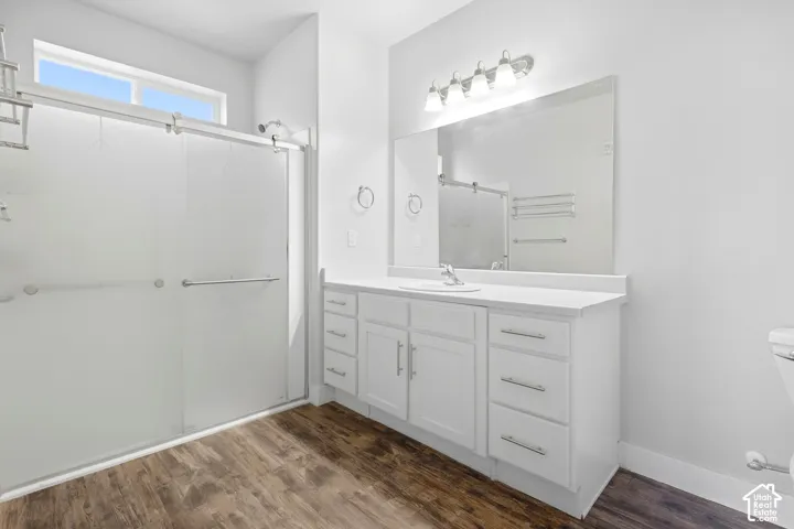 White vanity with integrated sink, coordinating countertop, and ample storage