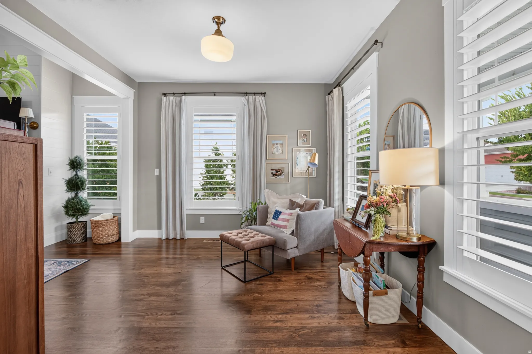 Hardwood-finish flooring throughout, white plantation shutters, white trim, recessed lighting, and an open entryway
