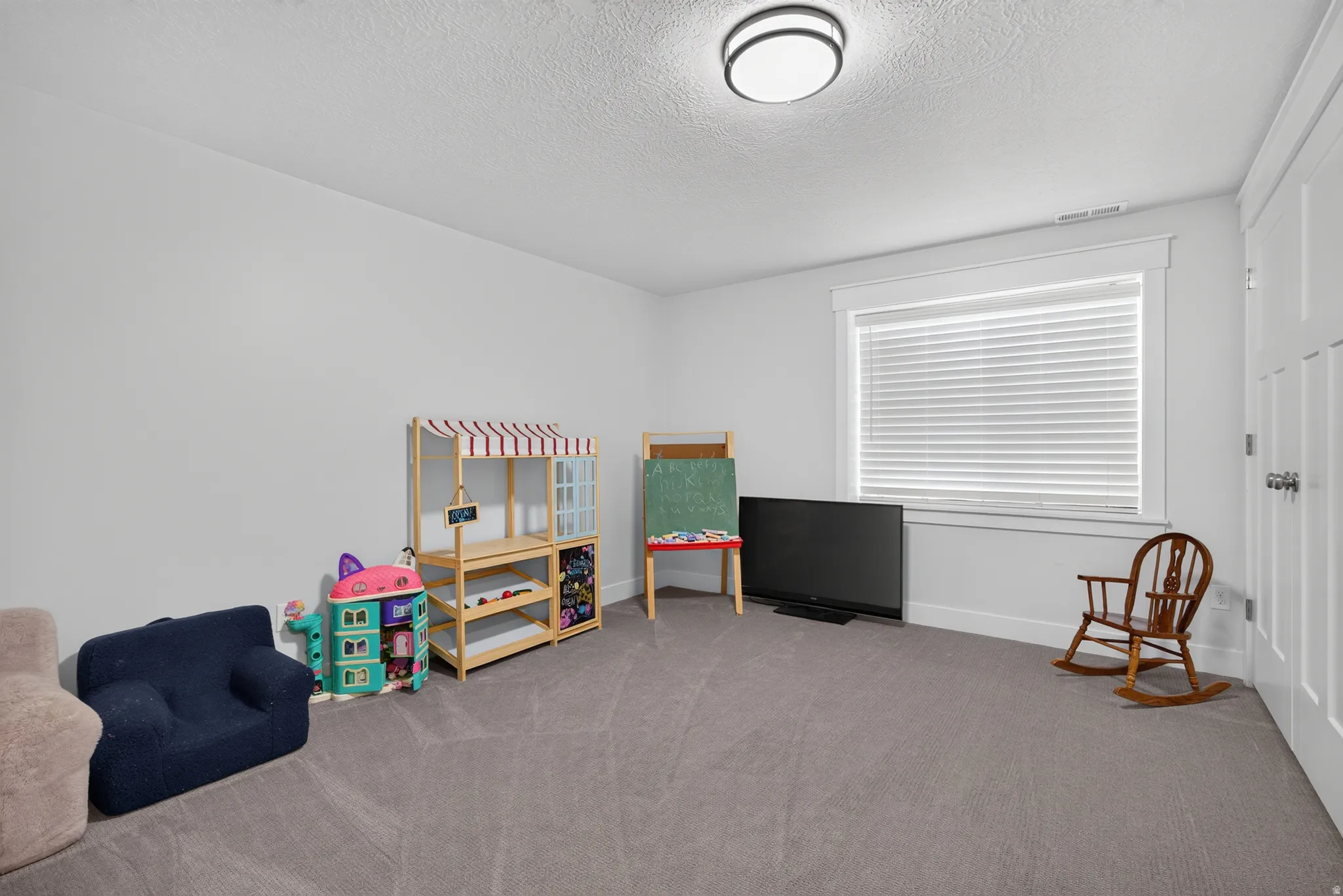 Room featuring neutral gray carpeting and white walls
