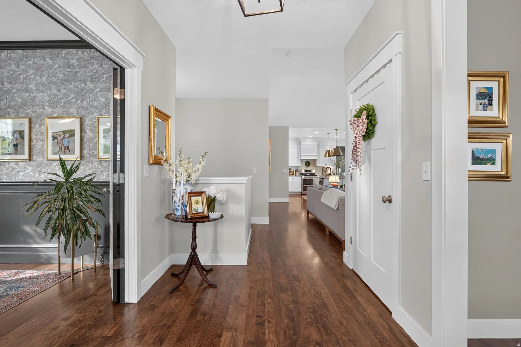 Hardwood flooring throughout, bright white trim, and a clear sightline to the kitchen