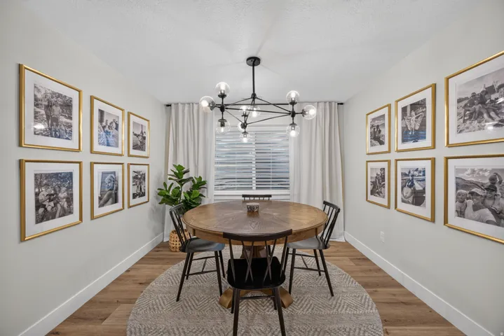 Recessed lighting, wood-finish flooring, and a modern chandelier
