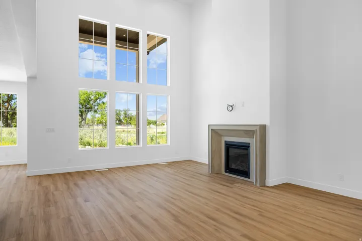 Vaulted ceilings, wood-finish flooring, and a stone-clad fireplace