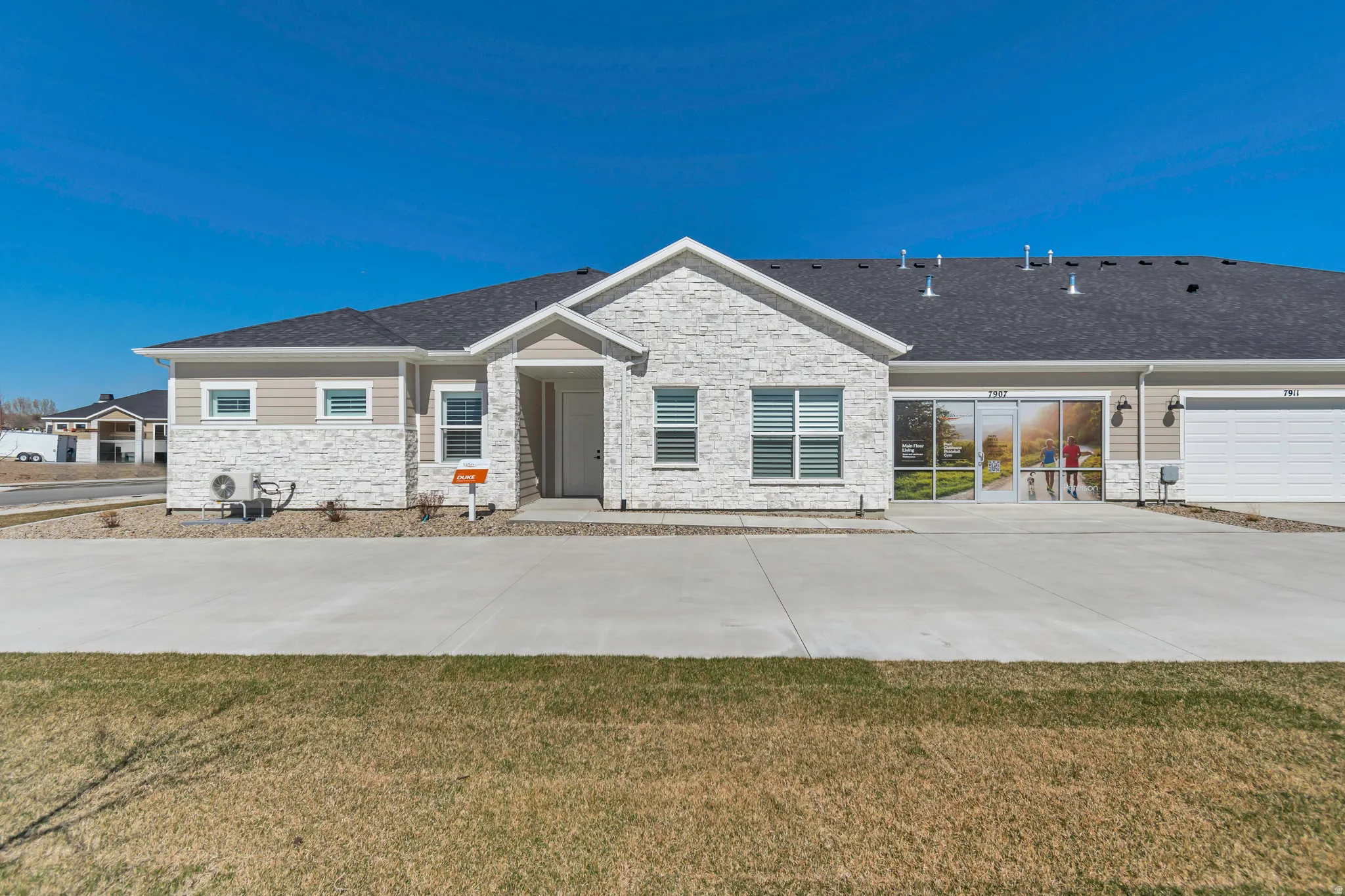 Exterior featuring a stone facade, horizontal siding, attached garage, and a concrete driveway