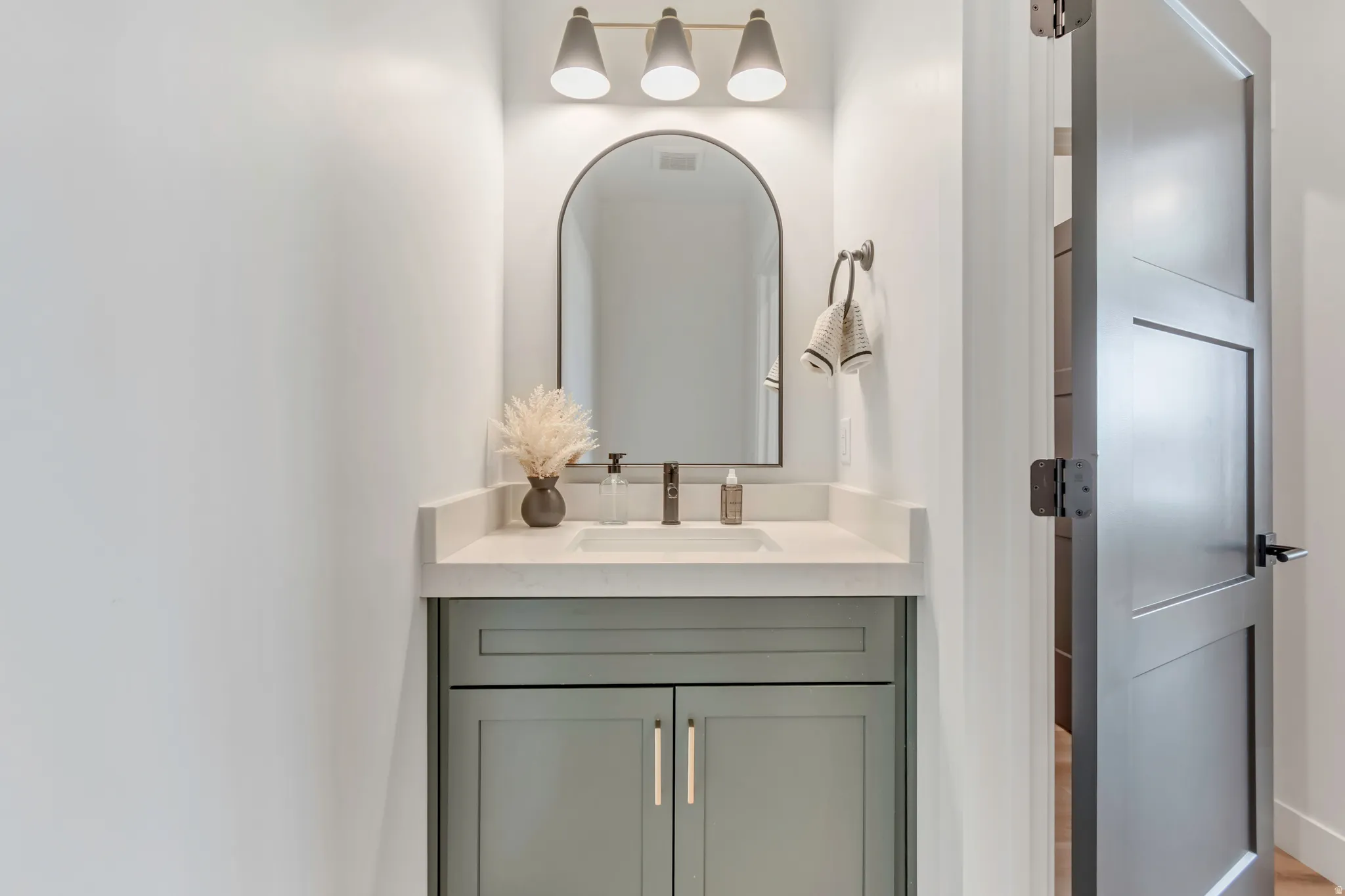 Sage green vanity with gold-tone hardware