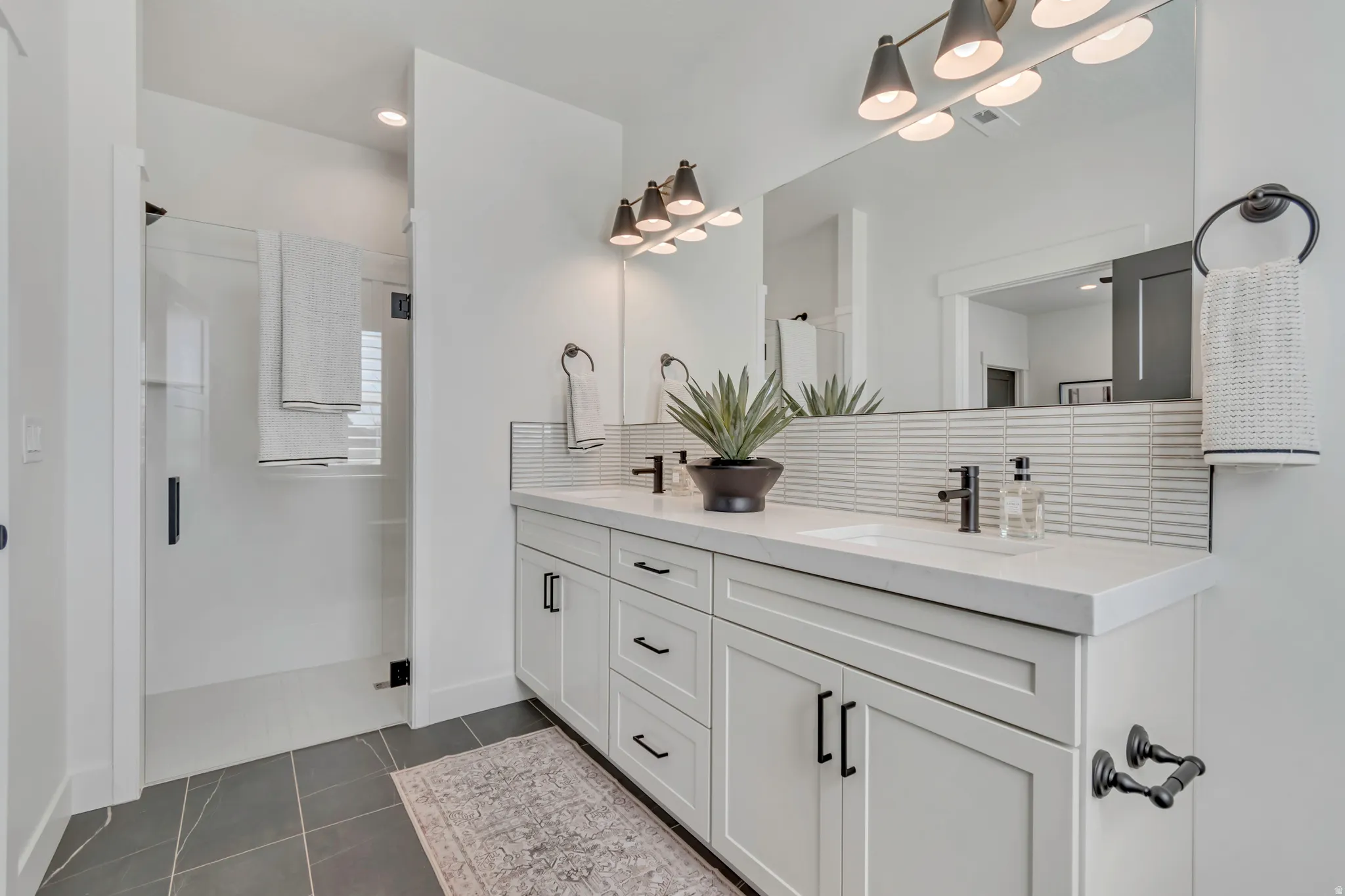 Dual vanity with integrated sinks, white countertops, and matte black fixtures