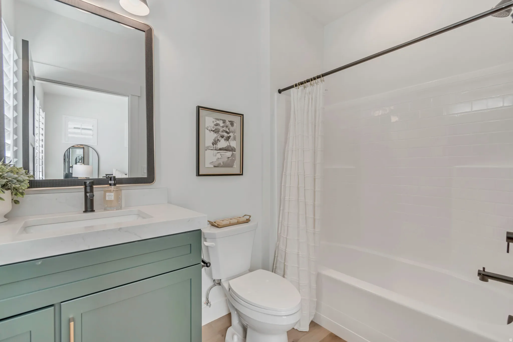 White subway tile shower surround with dark bronze fixtures