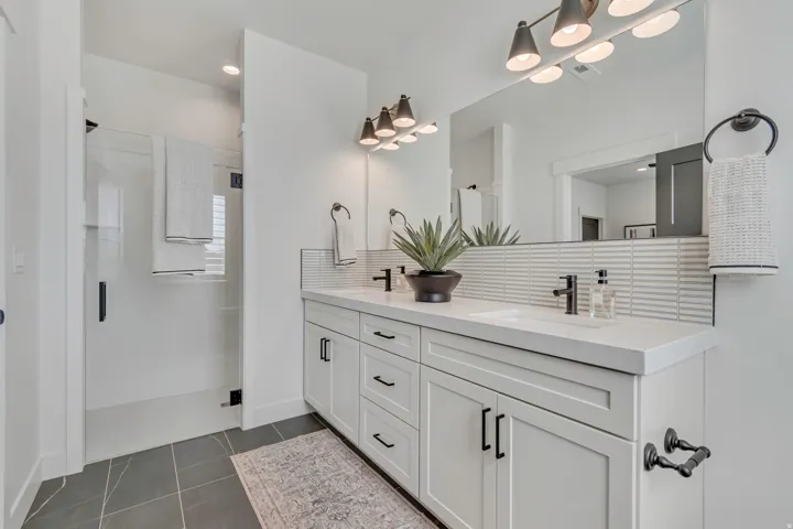Dual vanity with integrated sinks, white countertops, and matte black fixtures