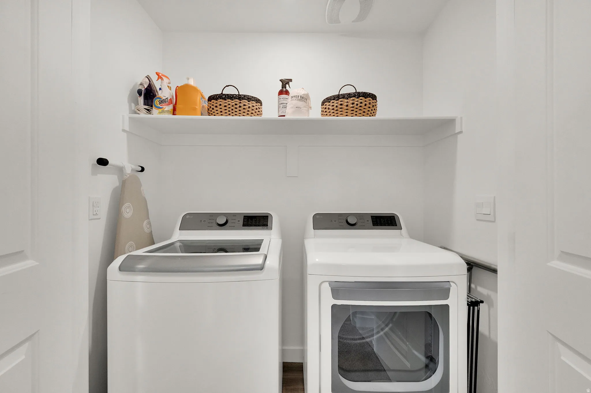 Dedicated laundry area featuring a built-in white shelf