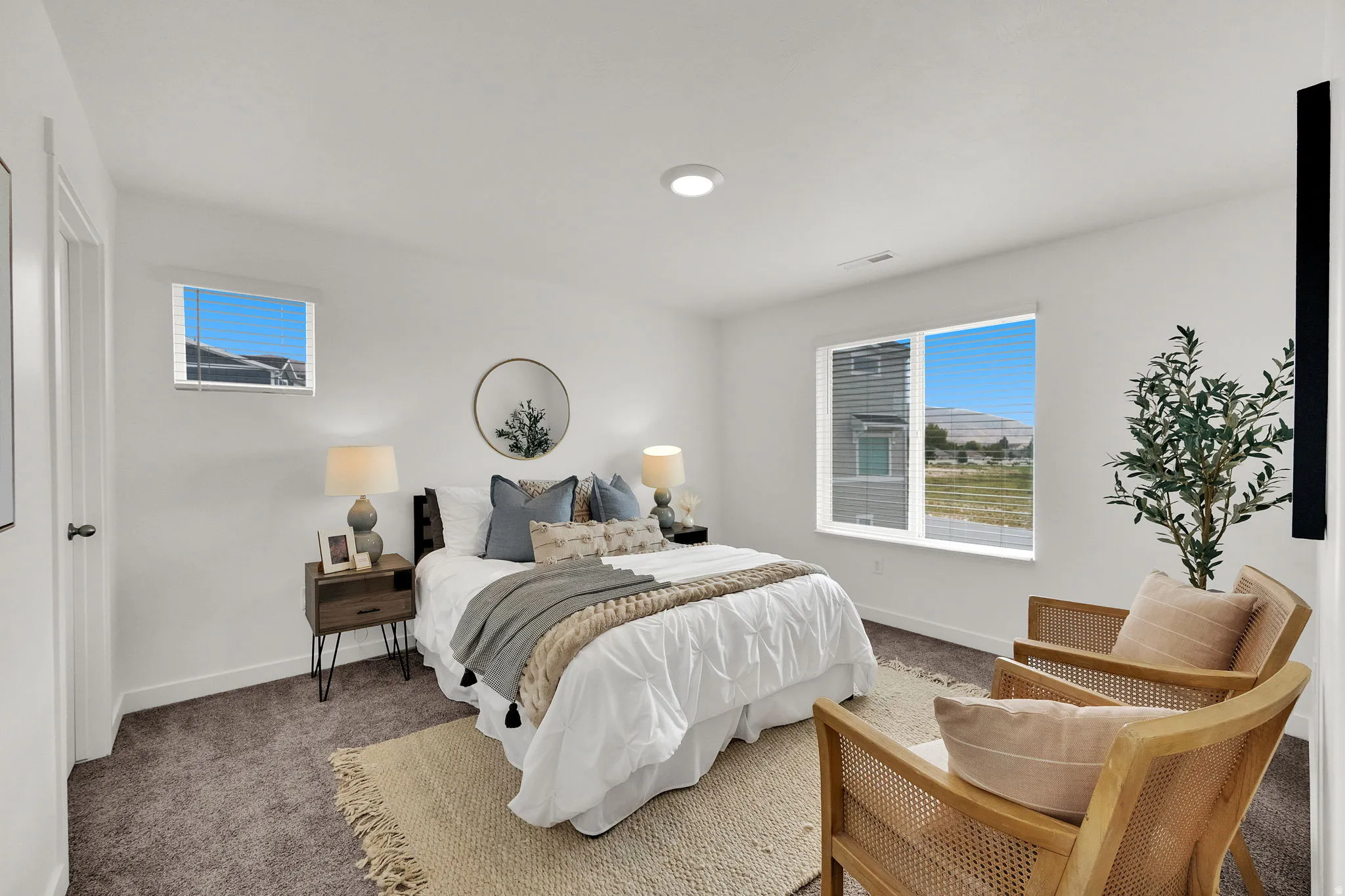 Expansive room with neutral carpeting, recessed lighting, and multiple windows providing ample natural light