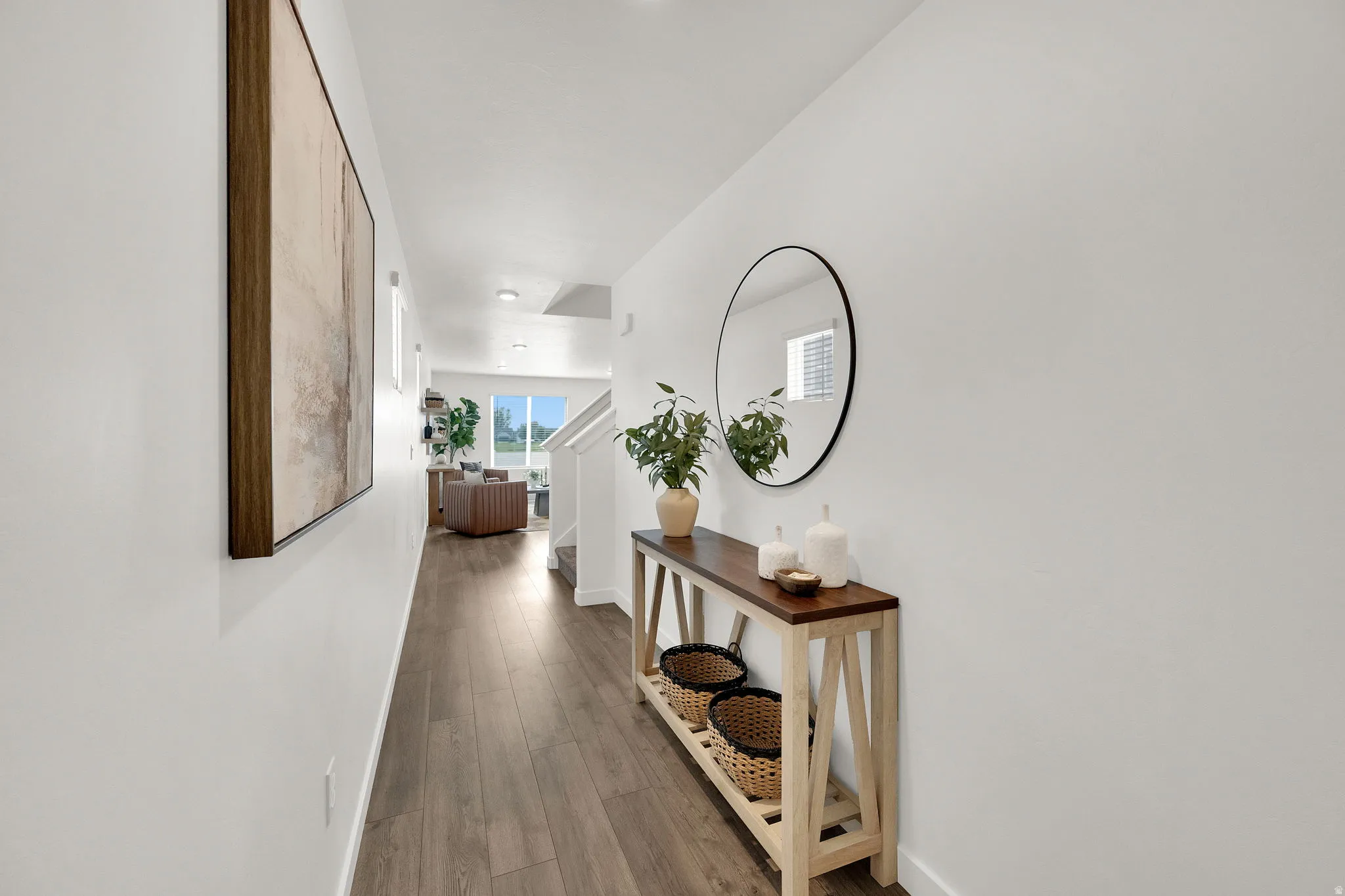 Wood-finish flooring throughout, white painted walls, and recessed lighting