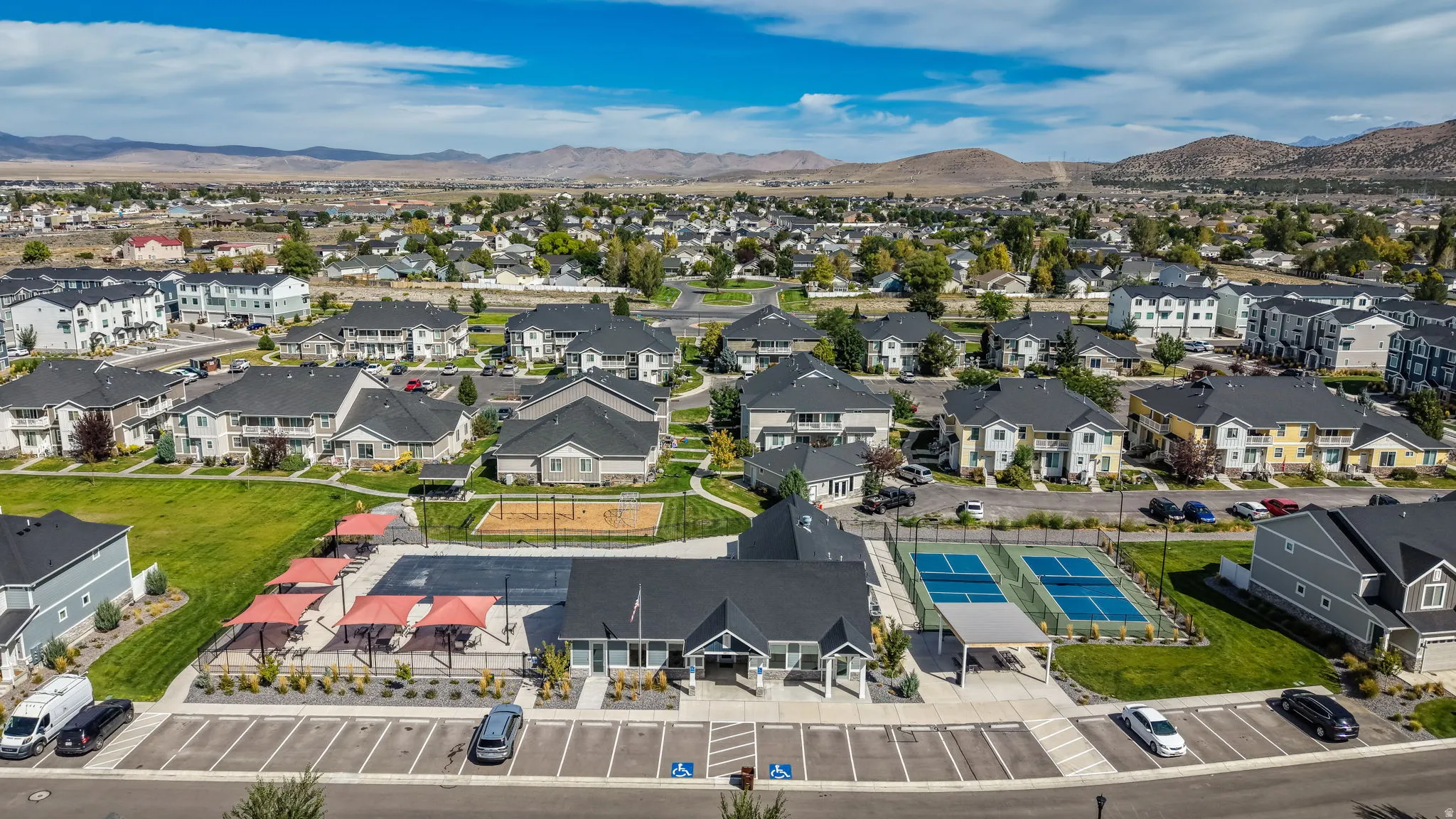 Community amenities include a dedicated parking area, pickleball courts, covered outdoor seating, and a playground