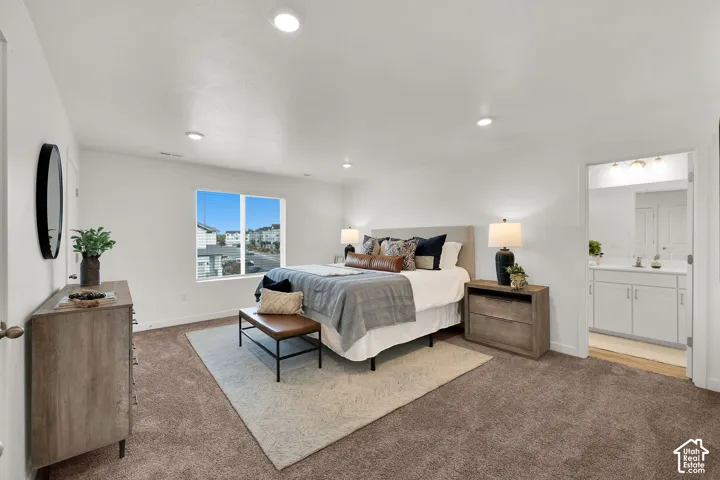 Recessed lighting illuminates a spacious room featuring a window with integrated blinds