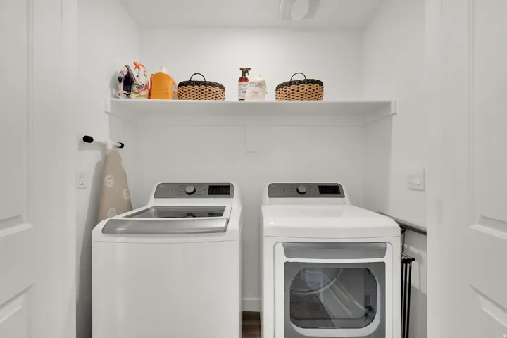 Dedicated laundry area featuring a built-in white shelf