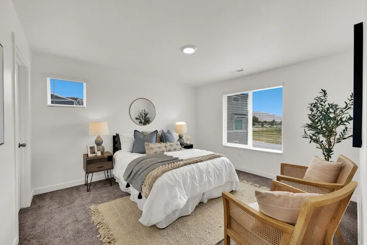 Expansive room with neutral carpeting, recessed lighting, and multiple windows providing ample natural light