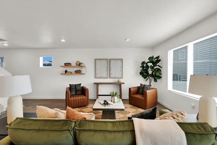 Recessed lighting, wood-finish flooring, white walls, and multiple windows with blinds