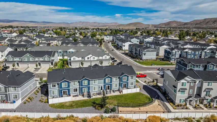 Contemporary residential development featuring multi-level townhomes with dark-toned roofs