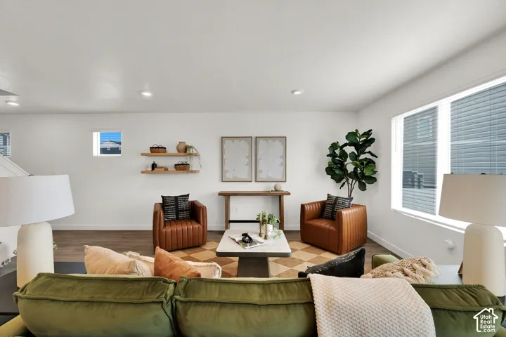 Recessed lighting, wood-finish flooring, white walls, and multiple windows with blinds