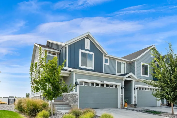 Contemporary facade featuring varied siding materials and stone accents