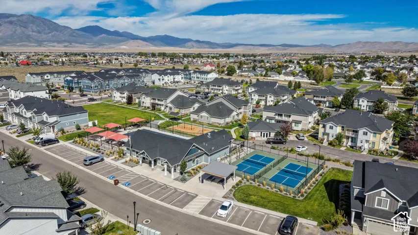 Community with multiple residential buildings, two outdoor pickleball courts, and a central green space