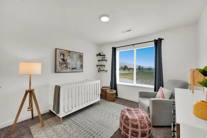Recessed ceiling lighting, a large window with blinds, dark curtain rods, wall-mounted shelving, and carpeted flooring