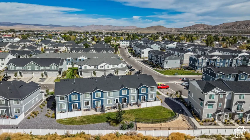 Contemporary residential development featuring multi-level townhomes with dark-toned roofs