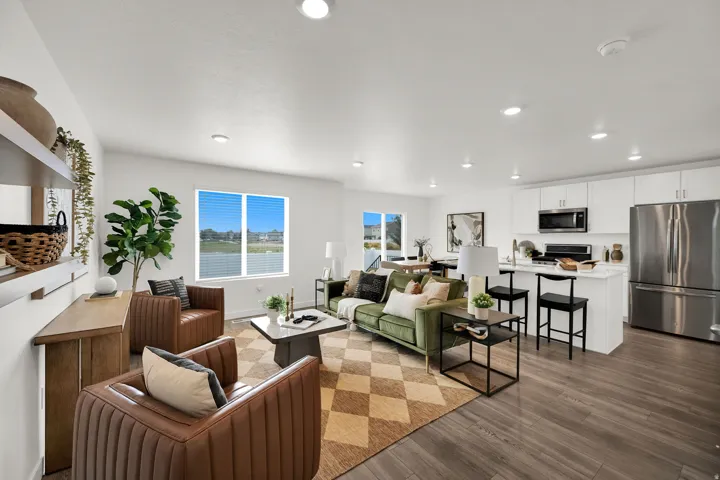 Open concept living area featuring wood-finish flooring, recessed lighting, and a kitchen island with seating