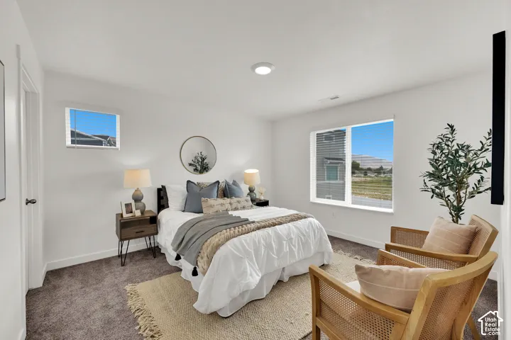 Expansive room with neutral carpeting, recessed lighting, and multiple windows providing ample natural light