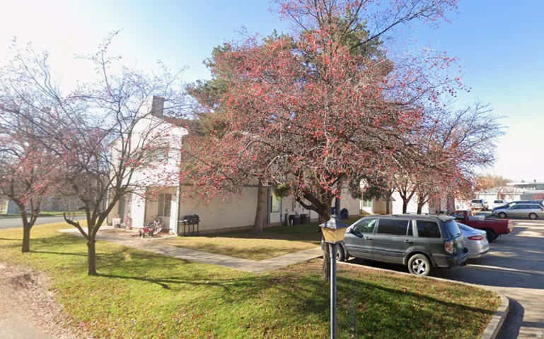 Two-story residential building with light-colored siding
