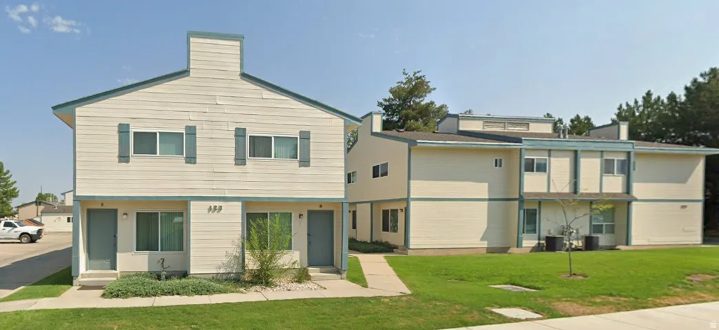 Two-story residential structures featuring exterior siding and multiple window units