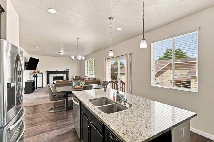 Kitchen island with a double basin sink and a stone countertop