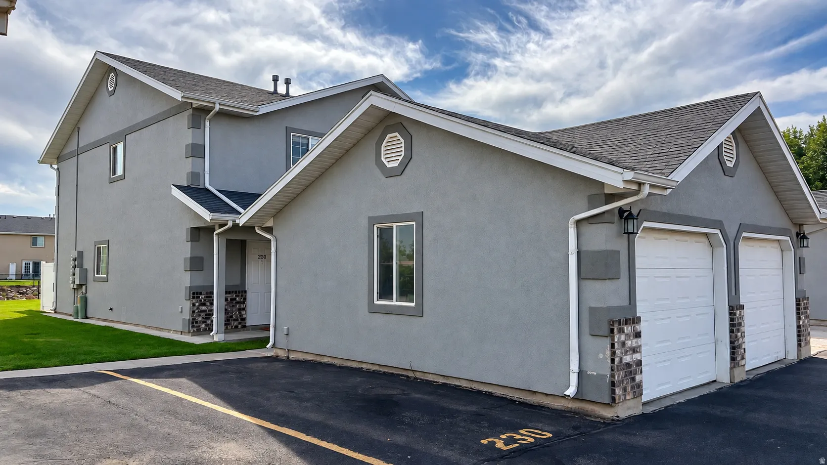 Contemporary exterior with a stucco finish and stone veneer accents