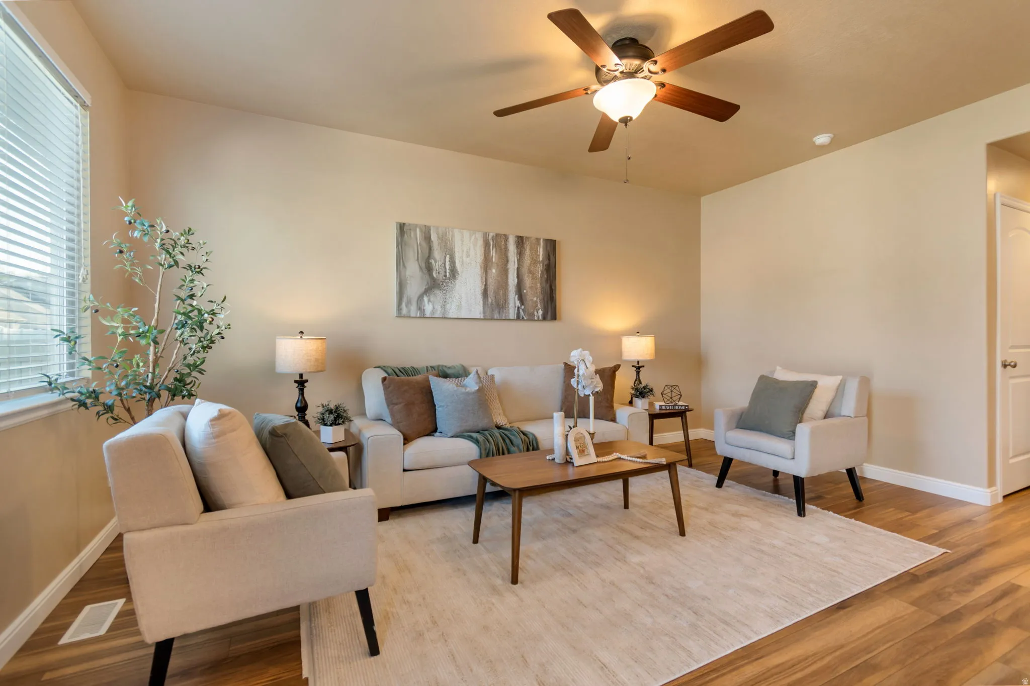 Recessed lighting, wood-finish flooring, and a ceiling fan with integrated lighting