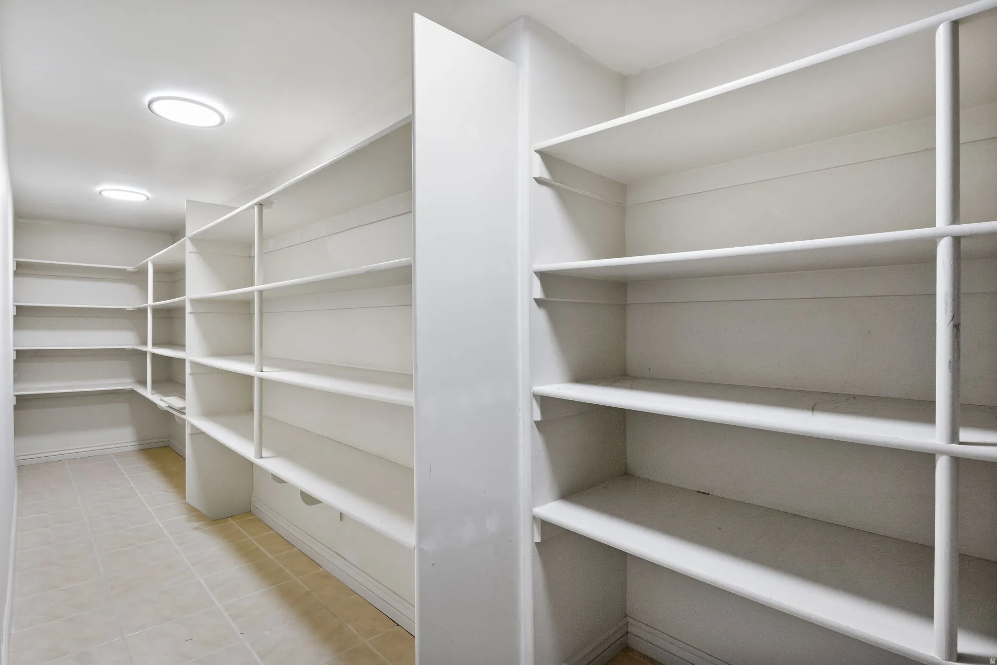 Recessed ceiling lighting, extensive built-in shelving, tiled flooring