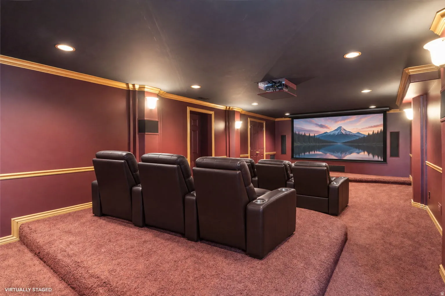 Dedicated home theater featuring a large projection screen and built-in speakers