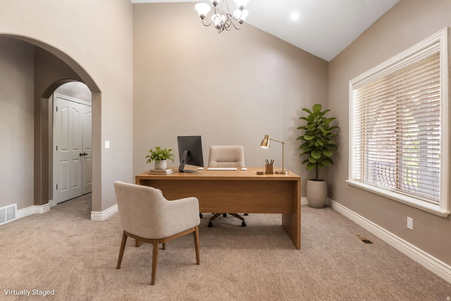 Vaulted ceiling with an elegant chandelier and recessed lighting