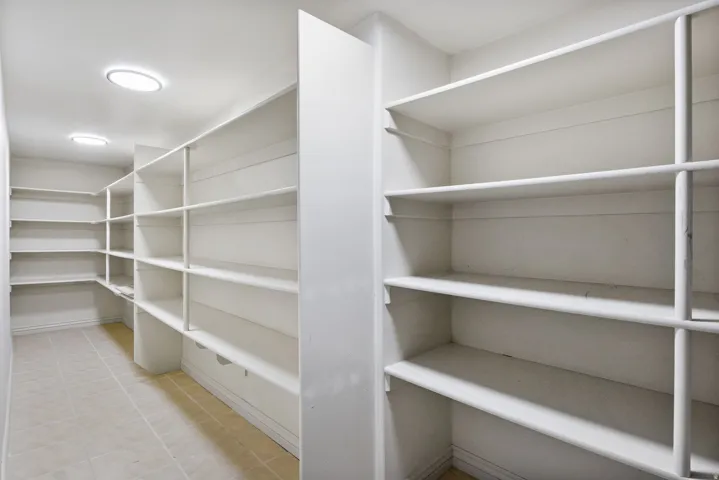 Recessed ceiling lighting, extensive built-in shelving, tiled flooring