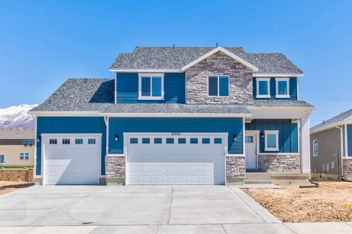 Two-story exterior with blue siding and stone accents