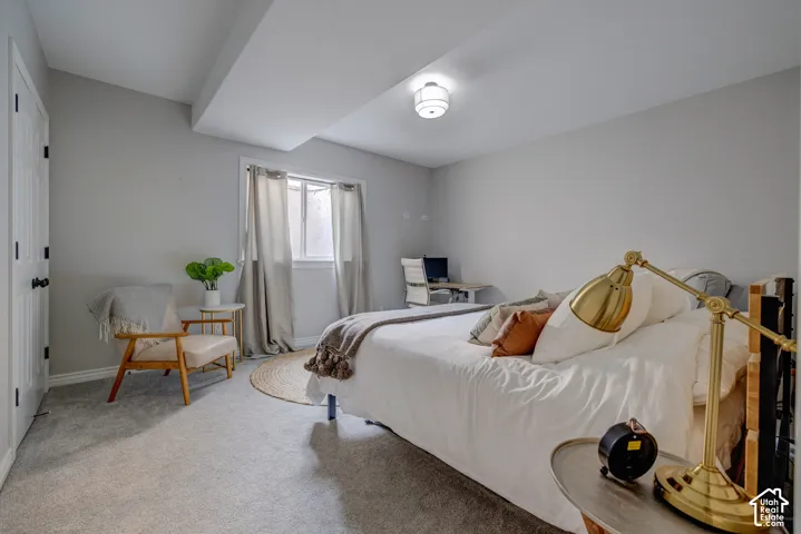 Soft gray carpeting throughout, recessed window, light gray wall paint, and overhead flush-mount lighting